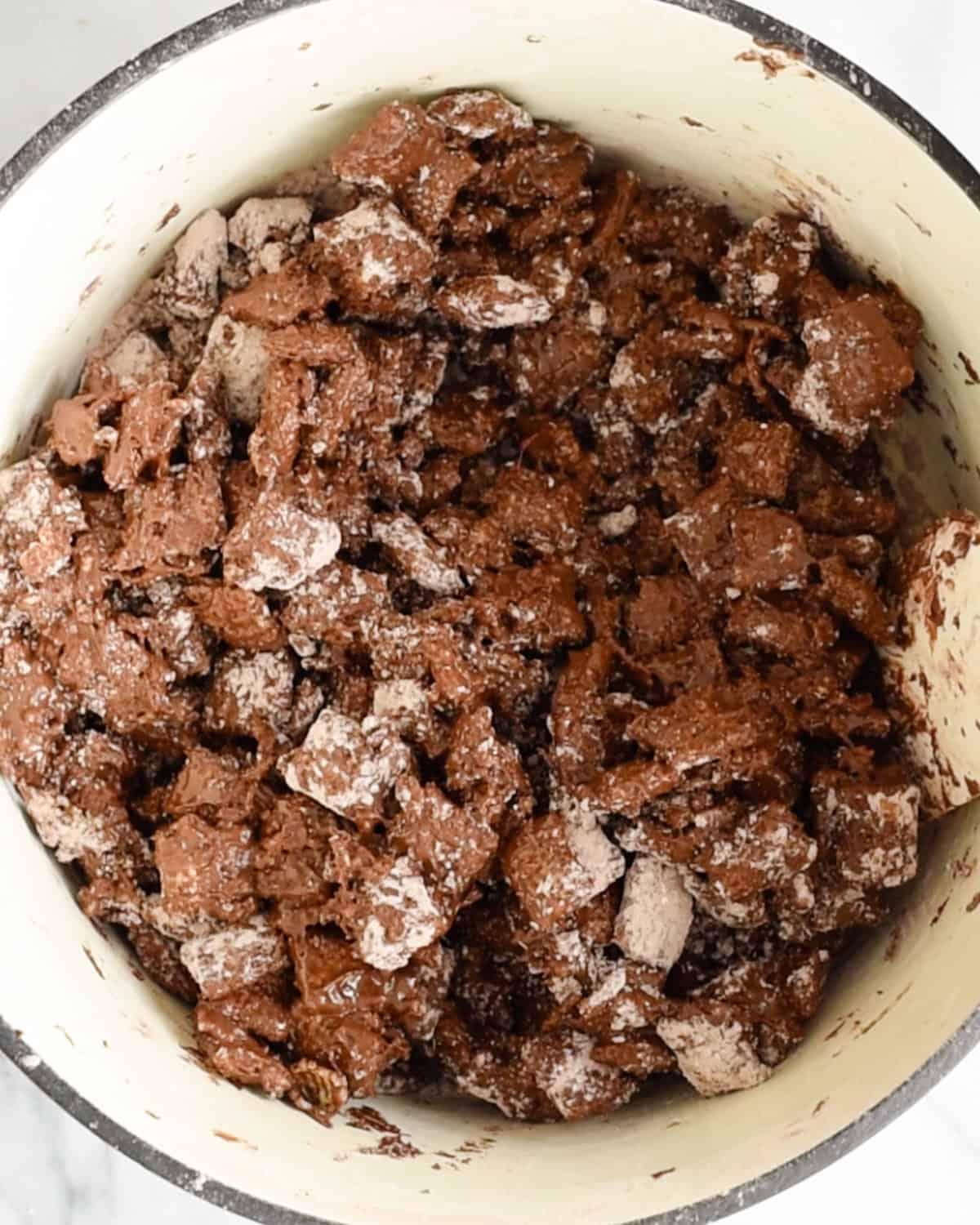 Πώς να φτιάξετε σοκολατένιο Puppy Chow - μετά το ανακάτεμα στο μείγμα ζάχαρης άχνης