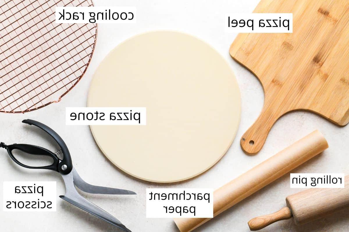 Φωτογραφία από πάνω του επισημασμένου εξοπλισμού που χρησιμοποιείται για την παρασκευή αυτής της σπιτικής πίτσας
