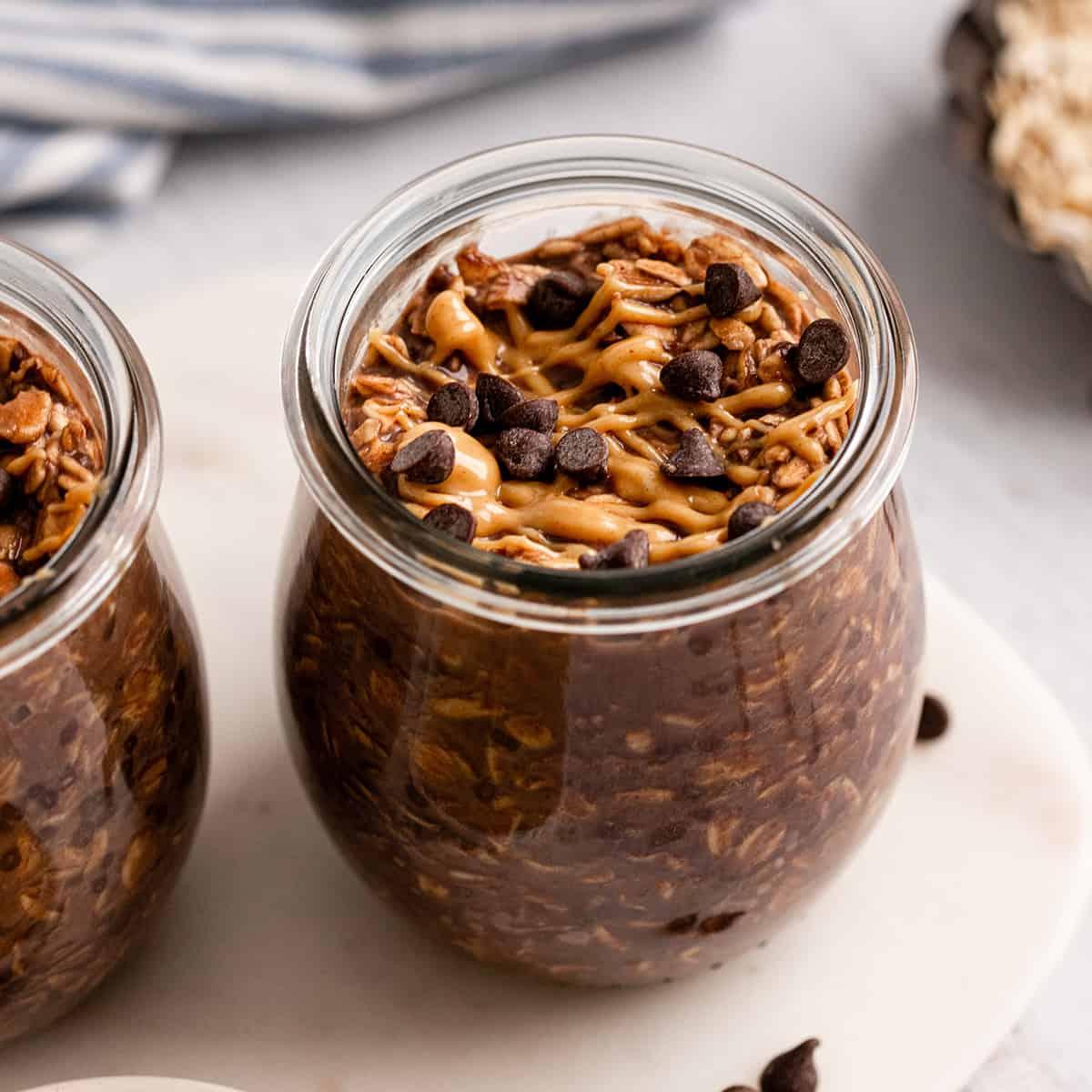a jar of Chocolate Peanut Butter Overnight Oats with peanut butter and chocolate chips on top