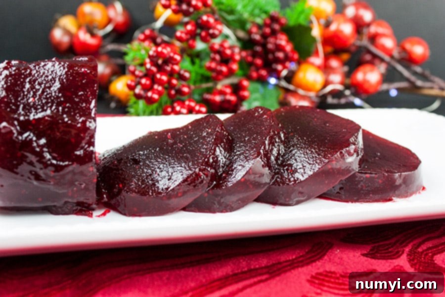 Easy Homemade Cranberry Sauce Your Way 8 Unmolded cranberry sauce shaped like a jar and sliced in serving slices on a white platter.