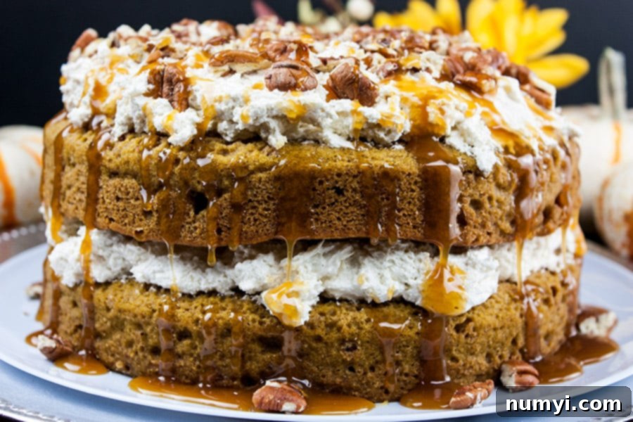 Easy Pumpkin Cake with Cream Cheese Filling on a festive cake serving plate, ready for holiday celebrations.