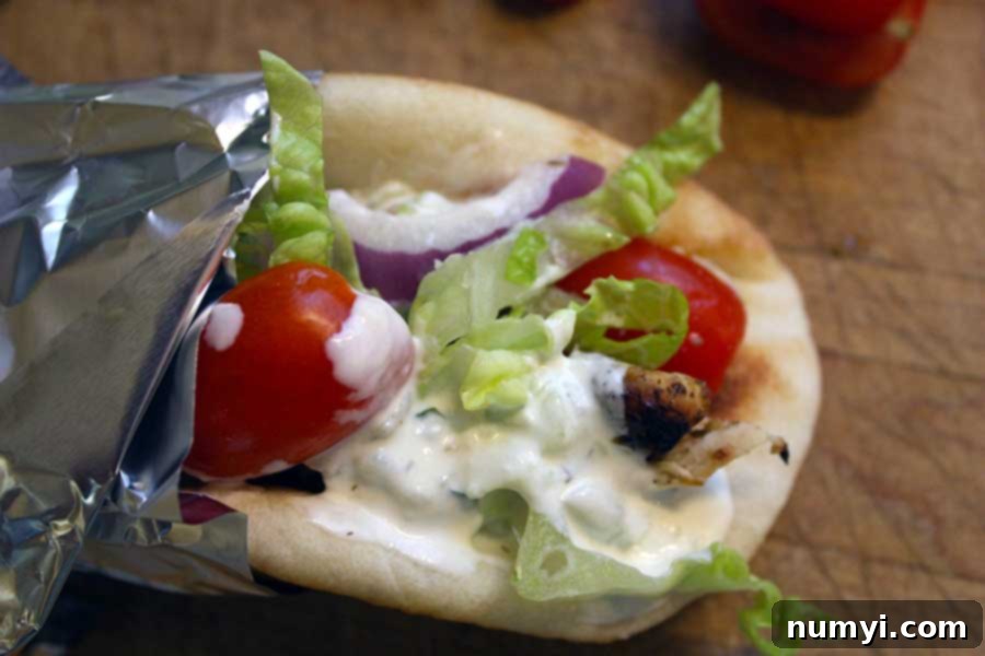 Chicken gyro on a wooden board.