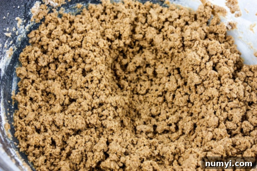 Crispy Gingersnap Cookies dough in a glass bowl, ready for mixing.