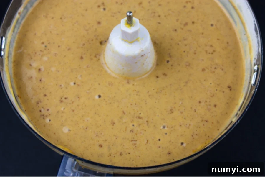 Gingersnap Crust pumpkin pie filling combined in the bowl of a food processor
