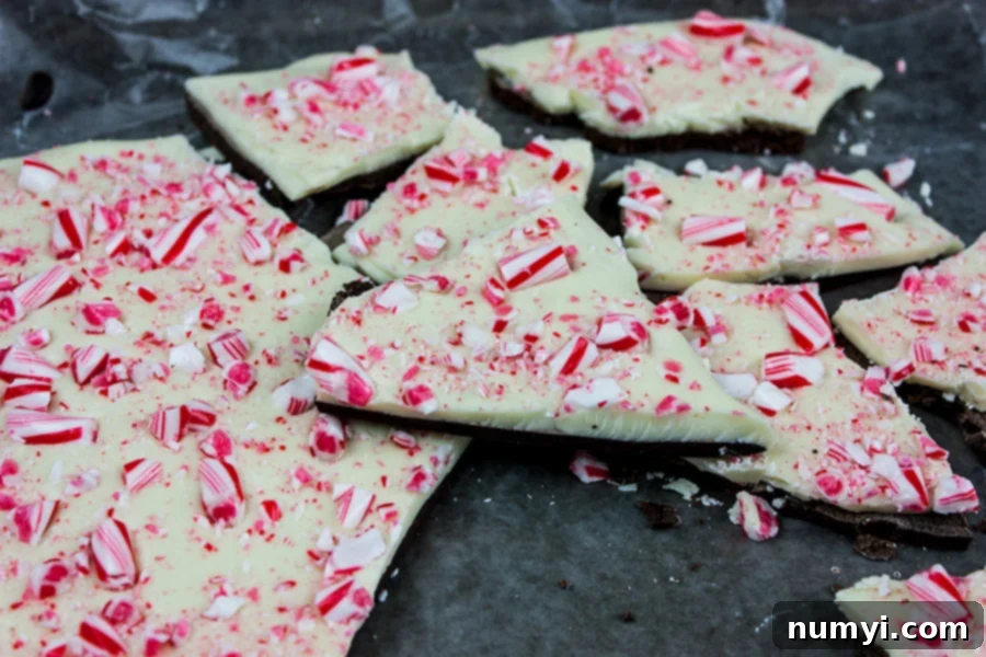 Peppermint bark broken into pieces on baking sheet.