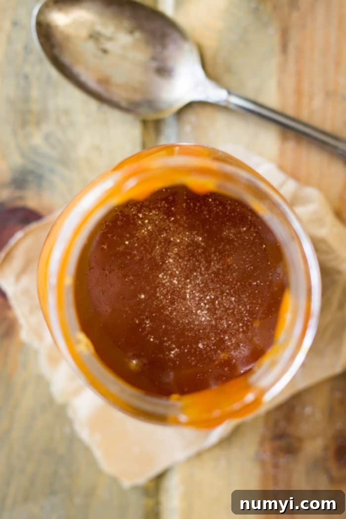 This Homemade Salted Caramel Sauce is incredibly easy to make with just a few ingredients, offering a superior flavor profile compared to store-bought options. Perfect for all your dessert needs!