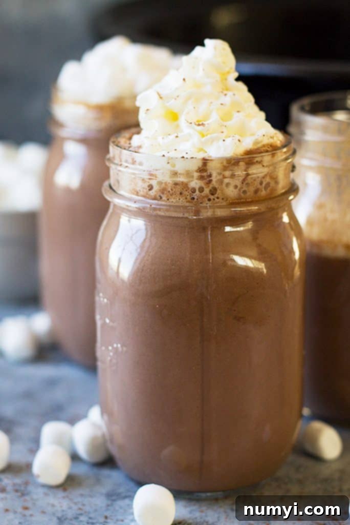This Slow Cooker Creamy Pumpkin Hot Chocolate is a great drink to celebrate the holidays! It's rich, creamy and totally comforting!