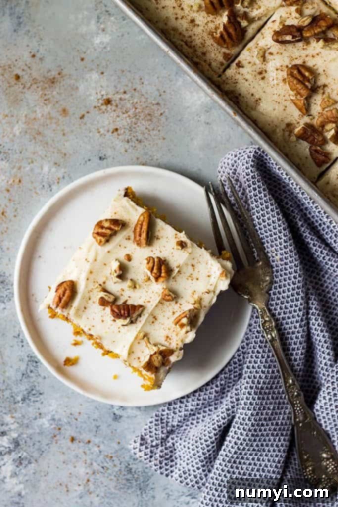 This Easy Pumpkin Cake with Cream Cheese Frosting is like a pumpkin cake roll only easier! It's moist and full of pumpkin spice making it the perfect fall dessert!