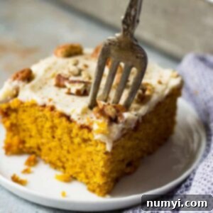 This Easy Pumpkin Cake with Cream Cheese Frosting is a lot easier than a pumpkin cake roll but tastes just like it! It's moist, full of pumpkin spice, topped with a dreamy cream cheese frosting and perfect for fall!