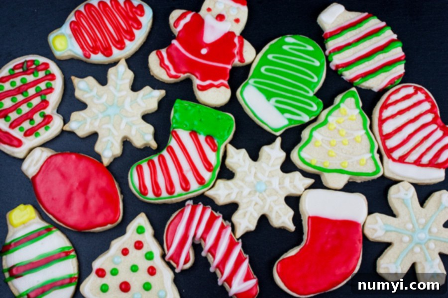 Beautifully decorated cut out sugar cookies with royal icing on a dark background.