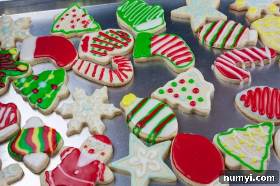 Rows of undecorated cut-out sugar cookies cooling on a wire rack after baking.