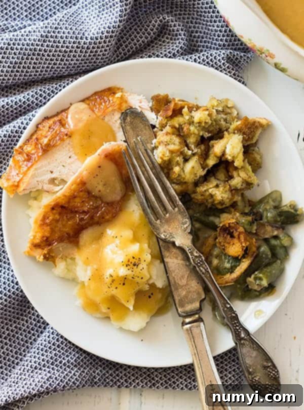 A festive Thanksgiving table setting with delicious food and elegant decor.