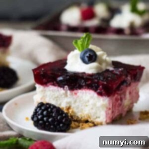 This Triple Berry Pretzel Salad is the perfect sweet and salty combo, with the salty pretzel crust, cream cheese middle, and fruity jello top! It's perfect at potlucks or family gatherings.
