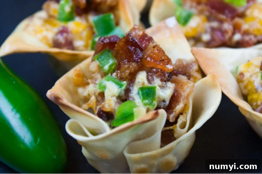 Close-up shot of Candied Bacon Jalapeno Poppers, highlighting the melted cheese, diced jalapenos, and crispy bacon bits.