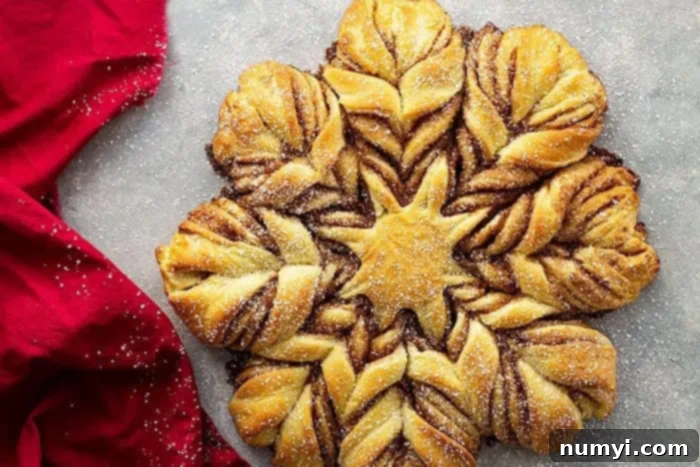 A dazzling Brioche Cinnamon Snowflake Christmas Bread, freshly baked and lightly dusted with powdered sugar, ready to be pulled apart and enjoyed.