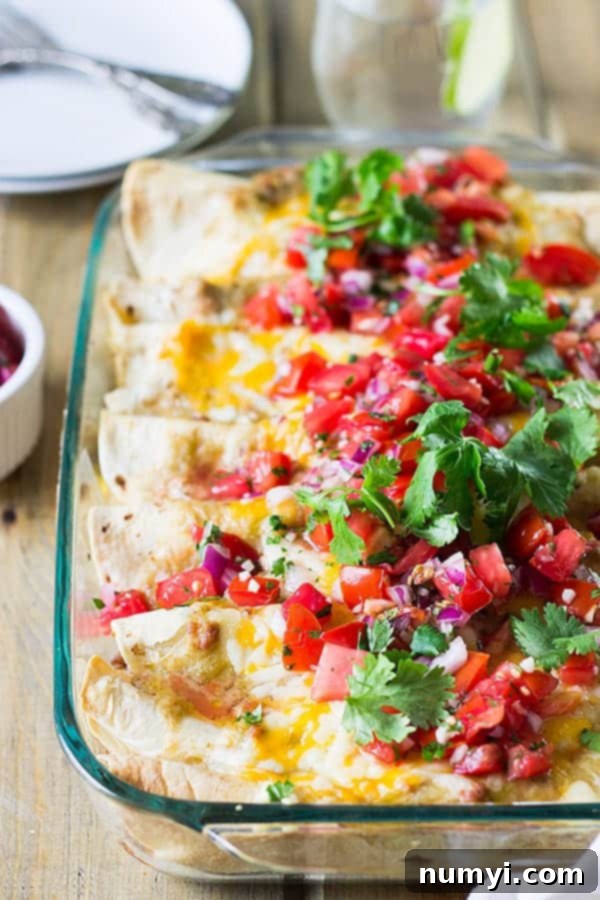 Breakfast Enchiladas are filled with scrambled eggs, sausage, green chilies and cheese! Perfect for weekend breakfast or brunch! | www.countrysidecravings.com