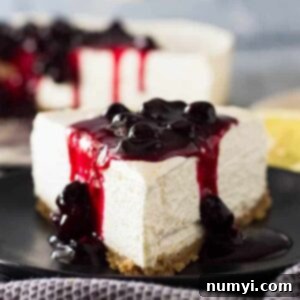 Close up of a slice of No Bake Lemon Blueberry Cheesecake with blueberry sauce on top.