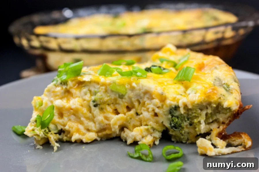 A close-up of the delicious Crustless Broccoli Cheddar Quiche, highlighting its fluffy, creamy texture and generous cheesy goodness. This low-carb dish is so flavorful, you won't miss the crust.
