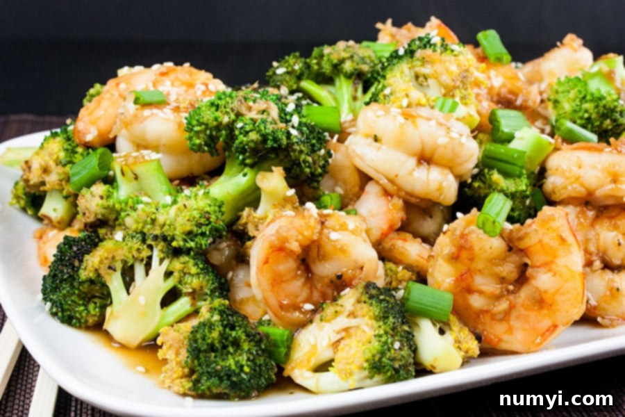 Shrimp and Broccoli Stir Fry on a white serving dish, garnished and ready to eat.