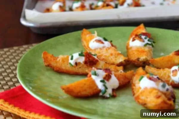 Crispy Potato Wedges elegantly served on a vibrant green plate, garnished with a generous dollop of sour cream, finely chopped green onions, and savory bacon bits for a tempting presentation.