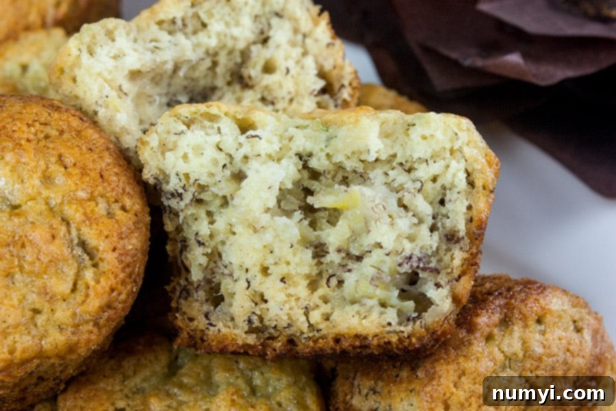 A Best Ever Banana Muffin cut in half, revealing its incredibly moist interior and tender texture.