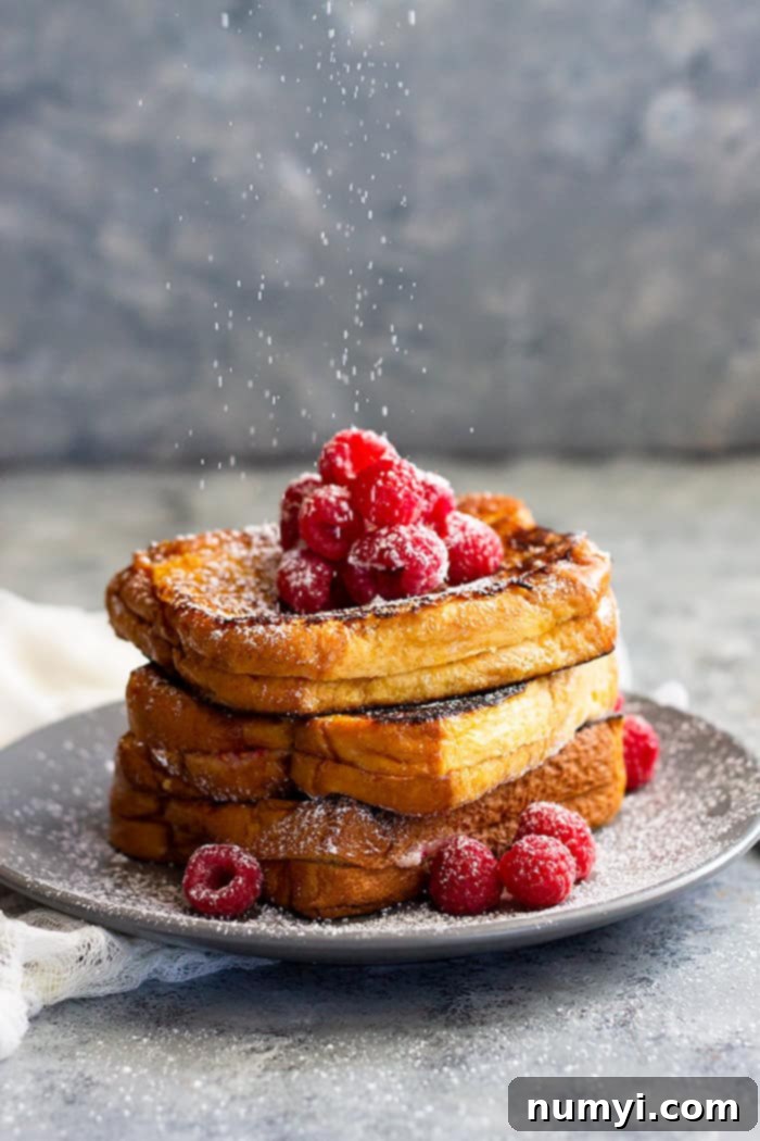 Raspberry Cheesecake Stuffed French Toast - a great brunch recipe for any special occasion! Rich and buttery brioche bread stuffed with raspberry cheesecake and drizzled with hot fudge sauce. Pure decadence for breakfast!