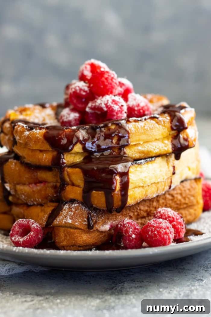 Raspberry Cheesecake Stuffed French Toast -is a very special brunch or breakfast! Buttery brioche bread stuffed with raspberry cheesecake filling then drizzled with hot fudge sauce! It's like dessert for breakfast!