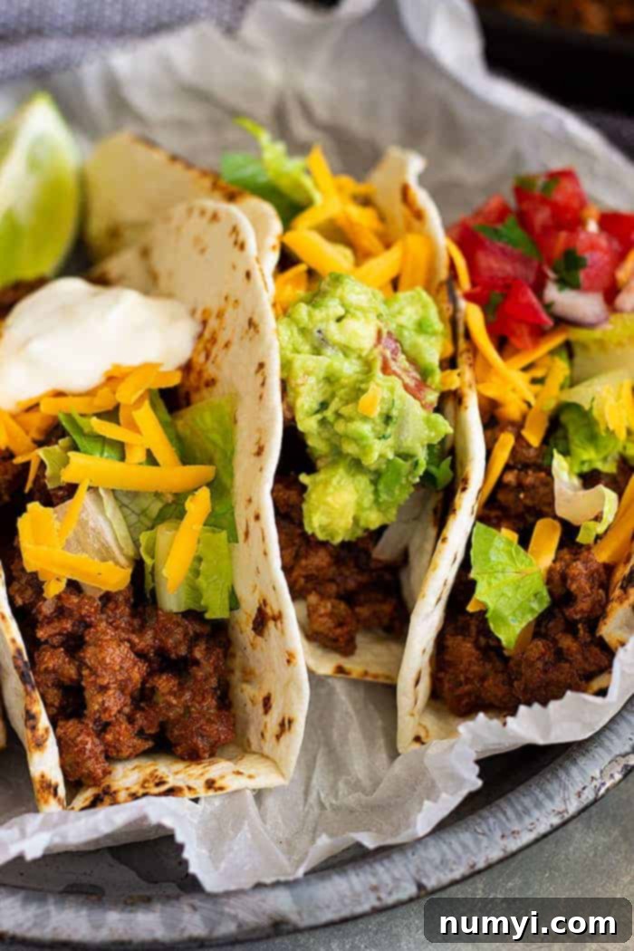 Close up of tacos made with the best taco meat recipe, garnished with fresh and colorful toppings.