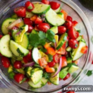 Vibrant Summer Avocado Salad 6 A vibrant and freshly made Tomato Cucumber Avocado Salad in a serving bowl, showcasing its healthy ingredients and inviting appeal.