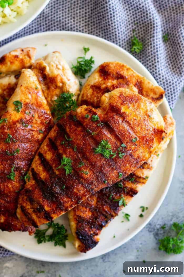cooked chicken on a plate, glistening with BBQ rub