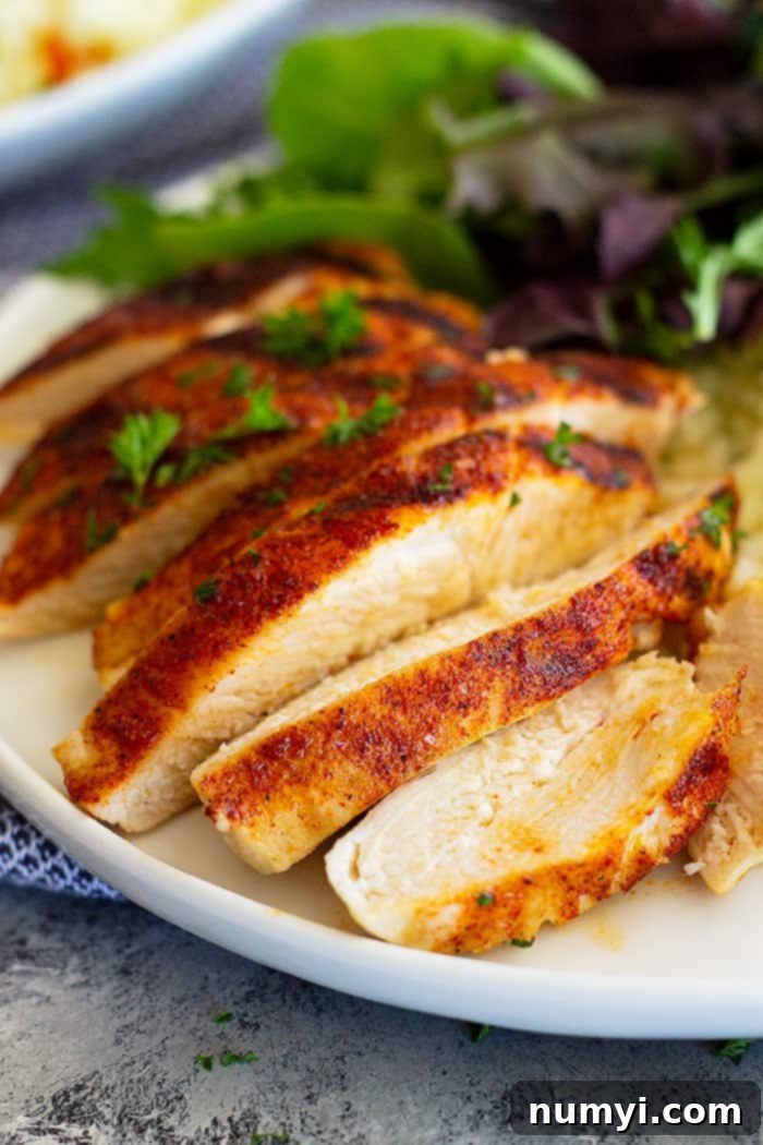 closeup of bbq chicken seasoning on a piece of chicken