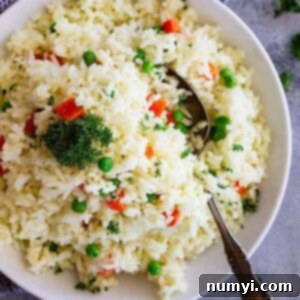 Easy Rice Pilaf with Carrots and Peas is a quick and easy side dish that pairs well with so many dishes! Great for casual weeknight dinners or for company.