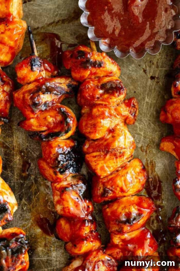 Homemade BBQ Chicken Skewers 2 overhead closeup: kabobs with bbq chicken marinade on a baking sheet