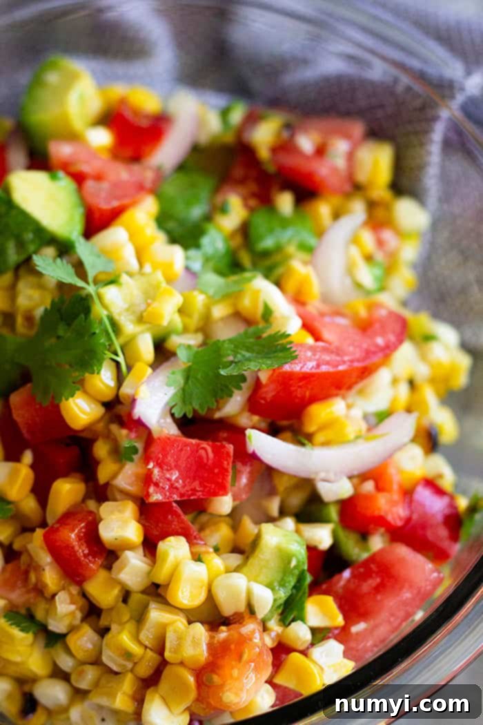 This Grilled Corn Salad with Tomato and Avocado is the perfect summer salad! It's light, healthy, easy to make, and can also make for a great lunch! #salad #summer #healthy #glutenfree