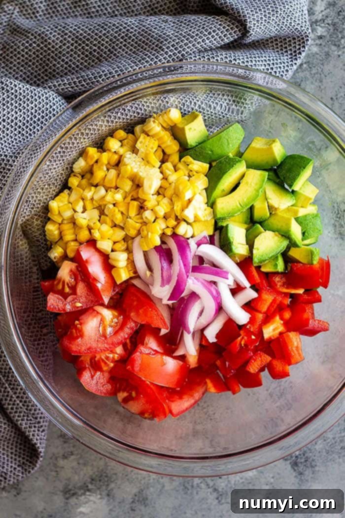 This Grilled Corn Salad with Tomato and Avocado is great paired with BBQ chicken, pork, seafood, or beef! It's the perfect summer salad! #salad #summer #healthy #glutenfree