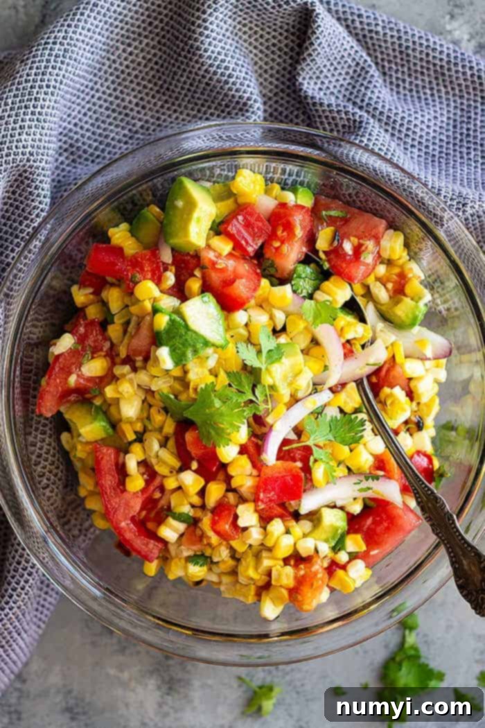 This Grilled Corn Salad with Tomato and Avocado is a healthy side dish that's great for a summertime BBQ! It's also great for a quick light lunch! #salad #summer #healthy #glutenfree