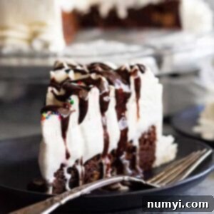 This Brownie Ice Cream Cake is an easy way to impress your guests. Chewy brownie on the bottom, topped with hot fudge sauce, vanilla ice cream, and a homemade whipped cream topping. #brownie #icecream #cake