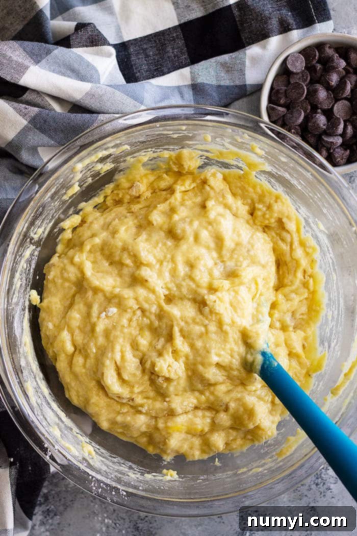 This Easy Banana Bread is a treasured family favorite! It's the BEST banana bread and it's perfect with additions like chocolate chips! #easyrecipe #bananabread #quickbread