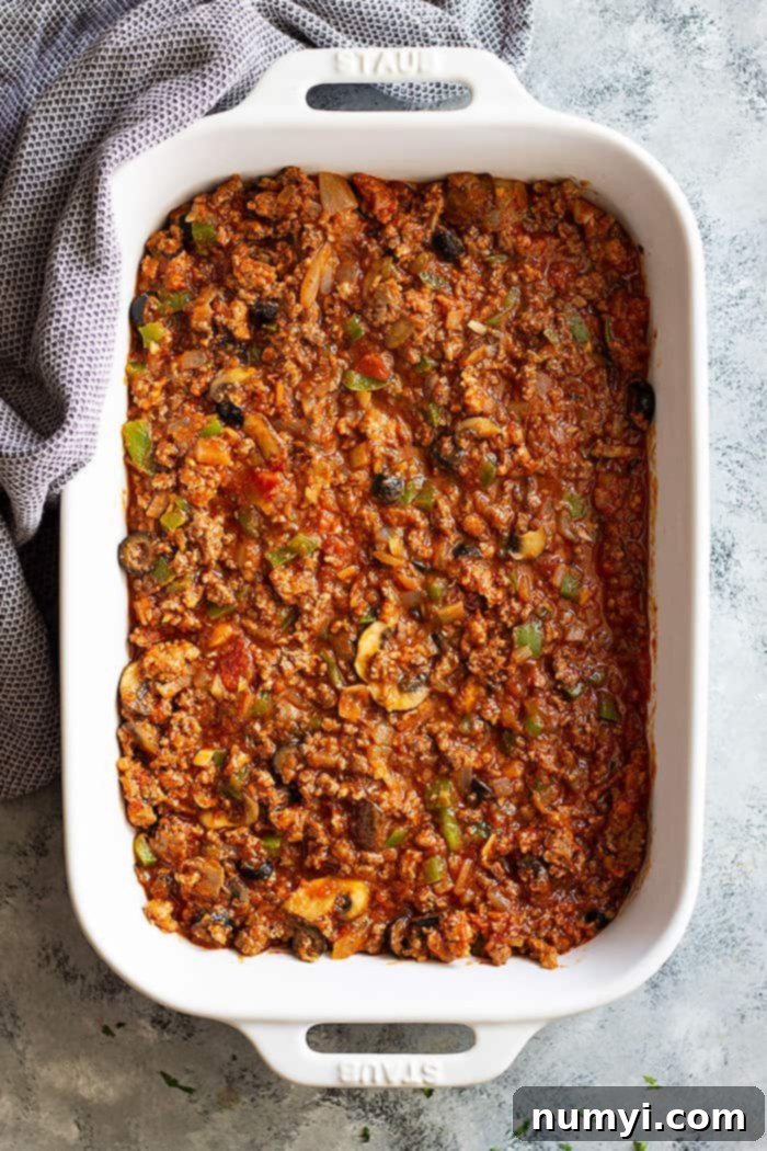 This Upside Down Pizza Casserole is comfort food made easy! Use store bought or homemade pizza dough or even biscuits! It's a great weeknight meal that will please the family! #easyrecipe #casserole #pizza