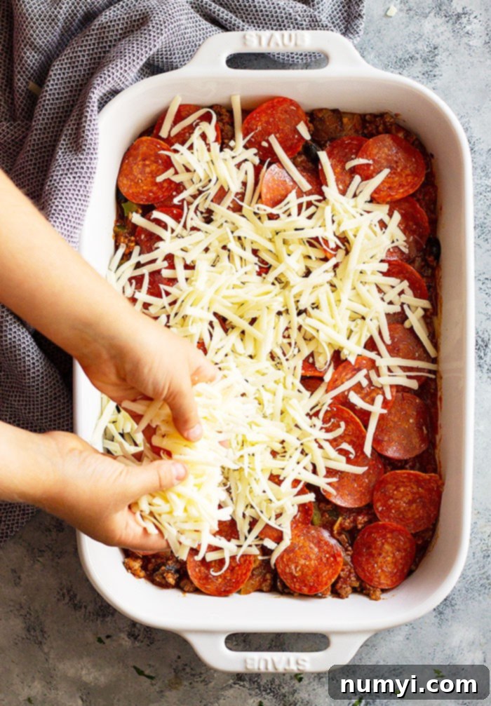 This Upside Down Pizza Casserole is comfort food made easy! Use store bought or homemade pizza dough or even biscuits! It's a great weeknight meal that will please the family! #easyrecipe #casserole #pizza