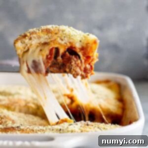 This Upside Down Pizza Casserole is filled with 3 meats, vegetables, and gooey cheese! Top with homemade or store bought pizza dough or even biscuits for the ultimate weeknight meal. #easyrecipe #casserole #pizza