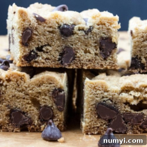 Freshly baked chocolate chip cookie bars cooling in a pan, highlighting their perfect texture and chocolate distribution.