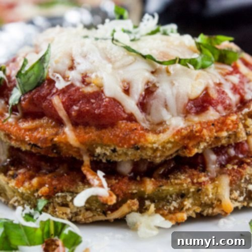 Effortless Sheet Pan Eggplant Parmesan 3 Sheet Pan Eggplant Parmesan on a white plate.