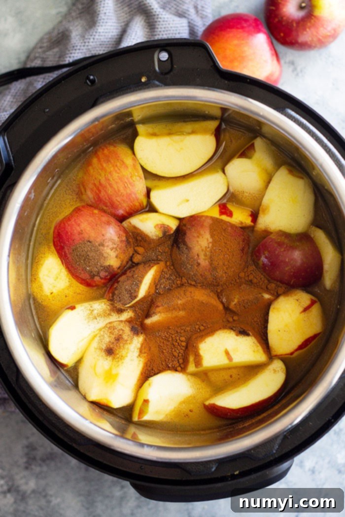 Homemade Apple Cider that's filled with warm spices like cinnamon, allspice, and a little clove. It's the perfect drink to warm up with! Slow cooker, Instant Pot, and stove top instructions included. #apples #applecider #easyrecipe #beverage