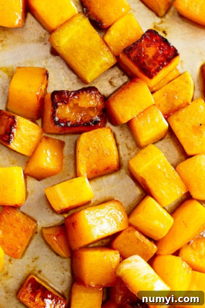 Delicious Maple Roasted Butternut Squash cubes, perfectly caramelized and glazed, ready to serve as a healthy and flavorful holiday side dish. This roasted vegetable recipe is ideal for Thanksgiving and Christmas gatherings.