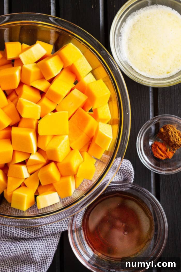 Butternut squash being peeled with a sharp vegetable peeler, demonstrating the initial step for preparing this easy healthy side dish for the holidays.