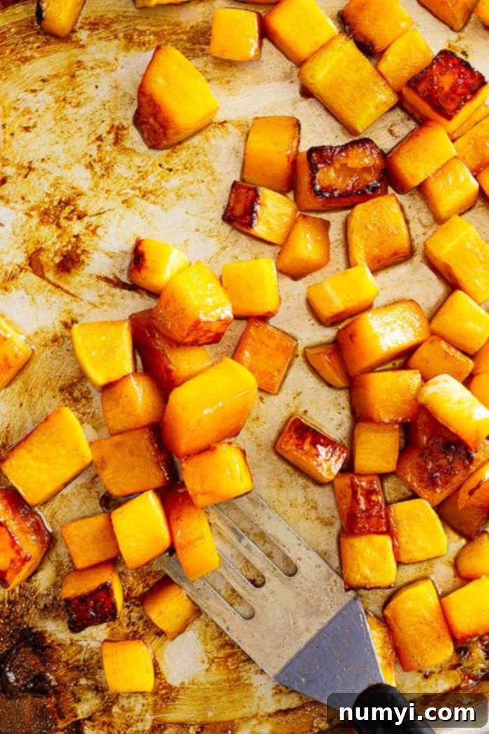 Uniformly cubed butternut squash, perfectly prepped and ready for roasting with maple syrup and spices. An essential step for creating this delicious and easy holiday side dish.