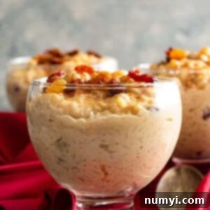 Silky Smooth Rice Pudding 6 A top-down view of creamy rice pudding, served in a rustic bowl, with a small spoon, ready to be enjoyed. #ricedessert #stovetoprecipe