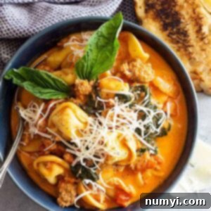 This Creamy Sausage and Tortellini Soup is the perfect comfort food! It's quick and easy to make and full of flavor! #souprecipe #tortellinisoup