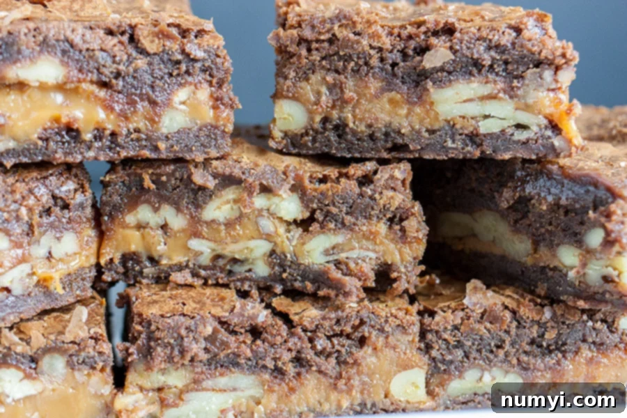 Decadent Turtle Brownies 2 Deliciously rich, fudgy turtle brownies with caramel and pecans, stacked high on a white plate, ready to be enjoyed.